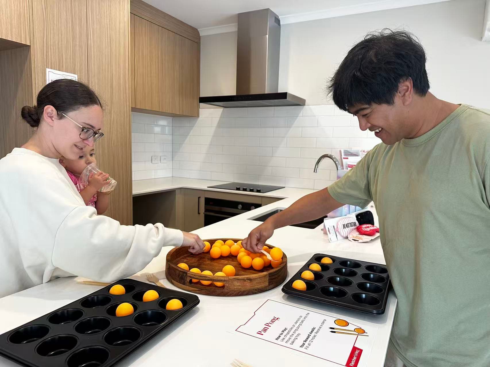 Family participating in a Fletcher Living community game inside a show home