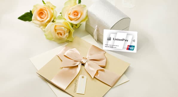 UnionPay International cardholder benefits image with a UnionPay card and gift presentation