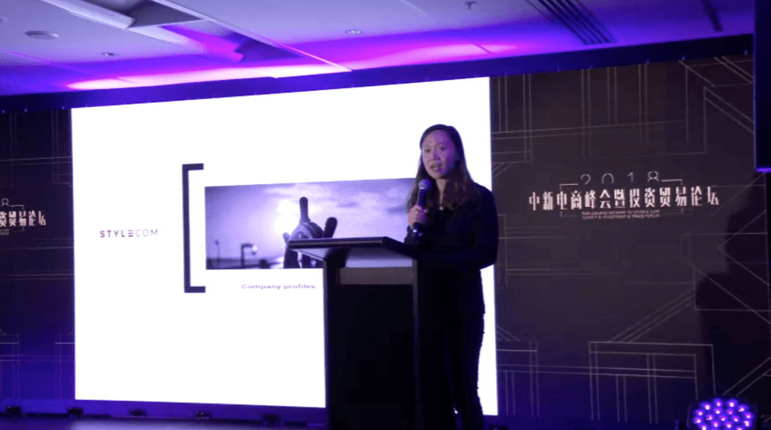 Stylecom presenting on stage at a cross-border commerce event